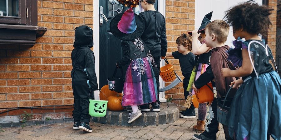 A group of kids trick-or-treating at a doorstep in South Carolina.