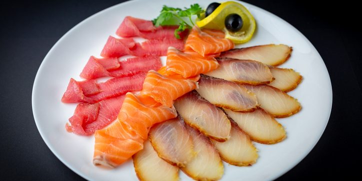 Sliced cold-smoked salmon, a type of smoked fish recalled in South Carolina over Listeria risk.
